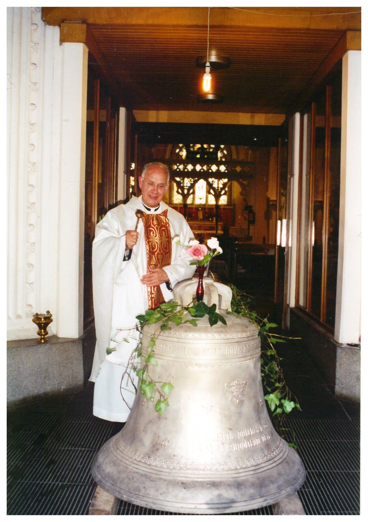 The_bell_receiving_blessing_from_Fr_Lavery.jpg